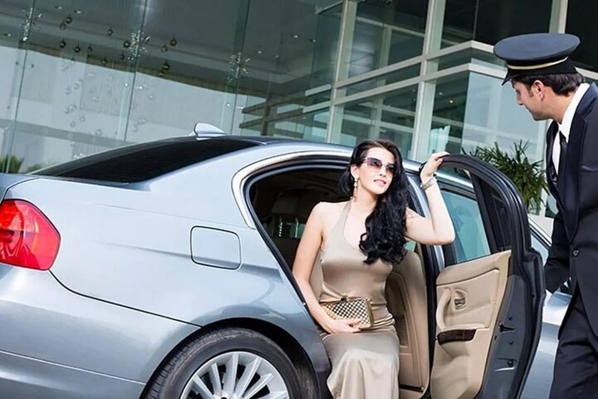 una mujer sentada en la puerta de un coche