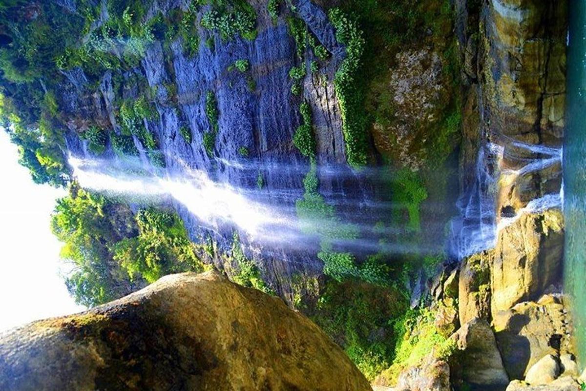 an aerial view of a waterfall on a rocky mountain