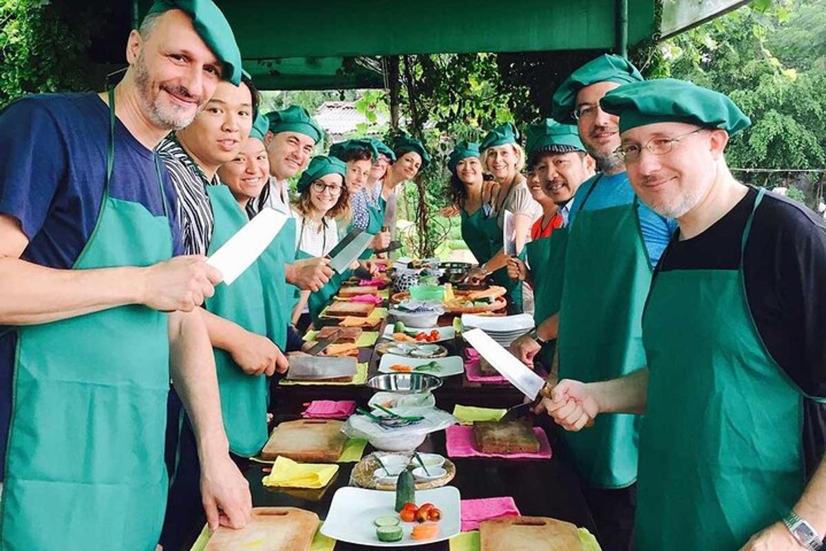 a group of people standing around a table with food
