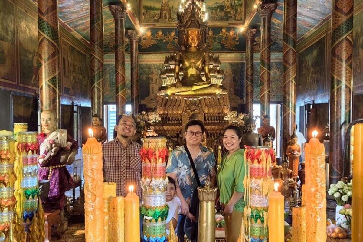 a group of people standing in a temple with candles