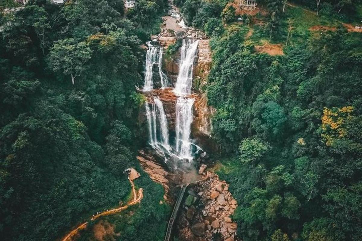 an aerial view of a waterfall in a forest