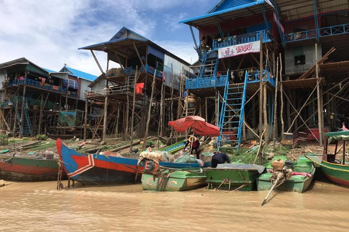 a group of boats in the water next to buildings