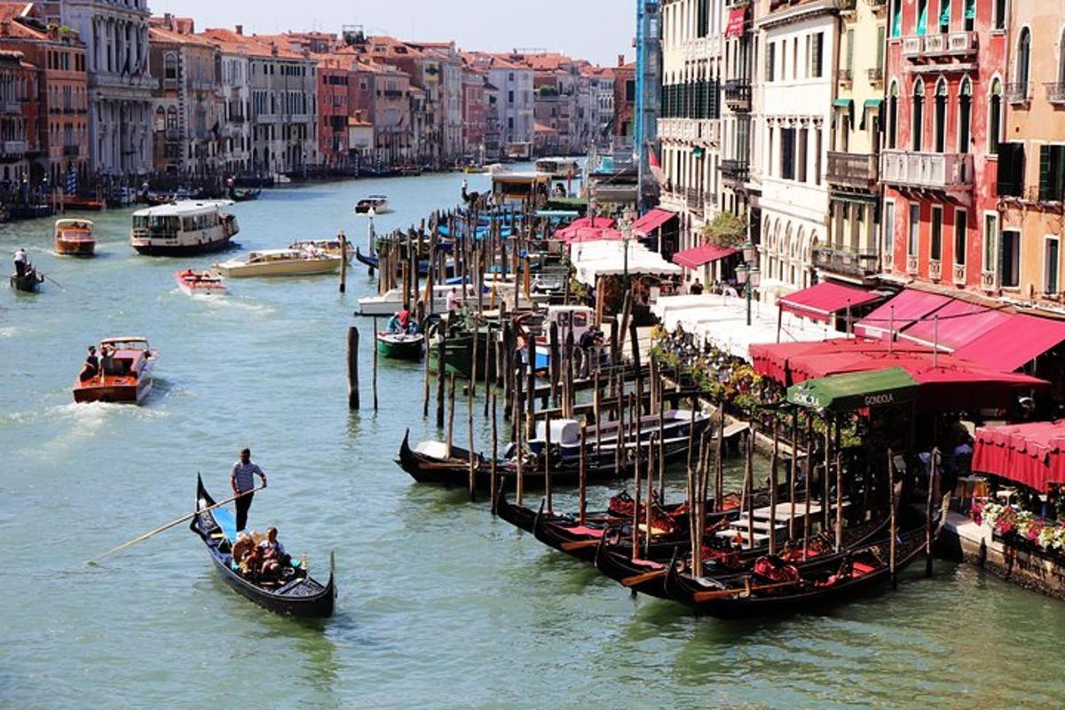 a group of gondolas on a river in a city