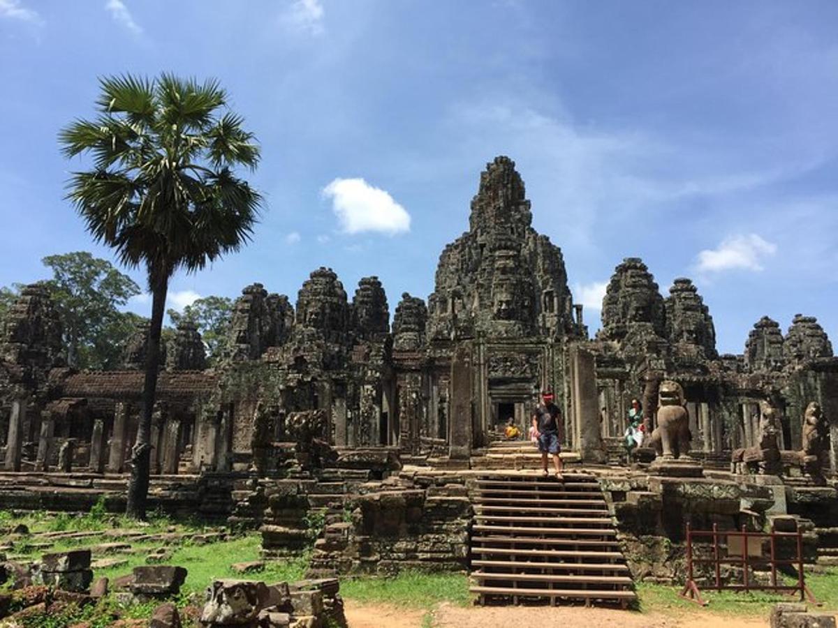 a person standing on steps in front of a temple
