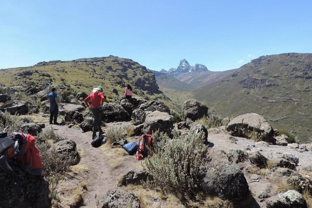 a group of people walking on a rocky mountain