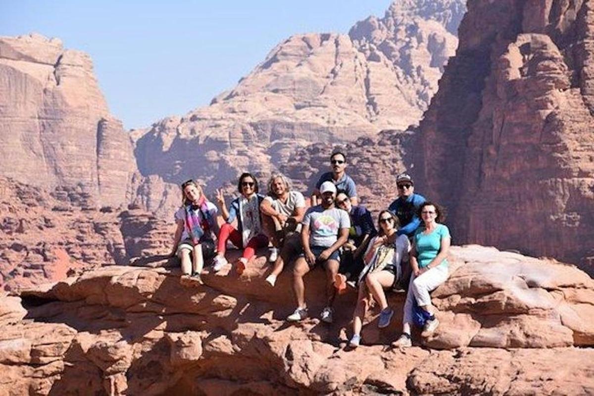 a group of people sitting on top of a mountain
