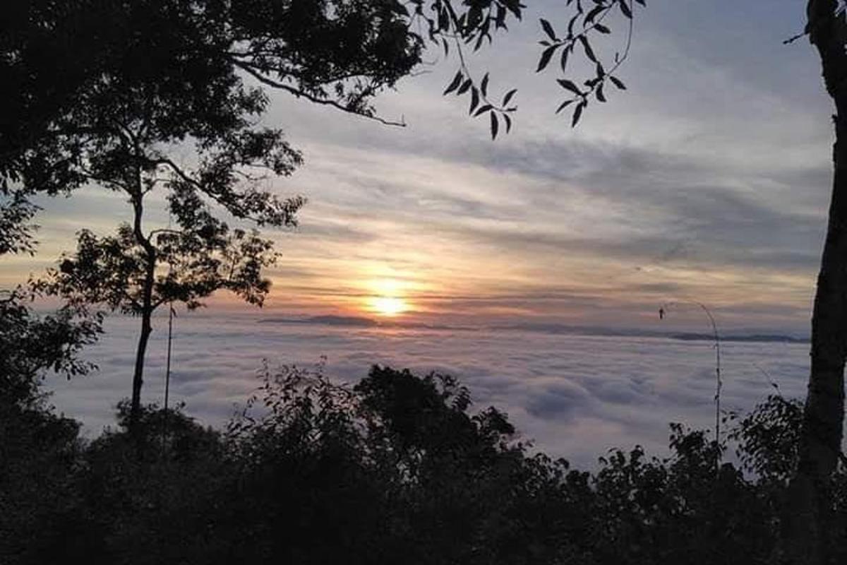a view of the sun rising above the clouds