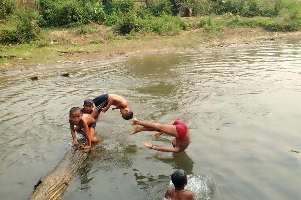 a group of children playing in the water