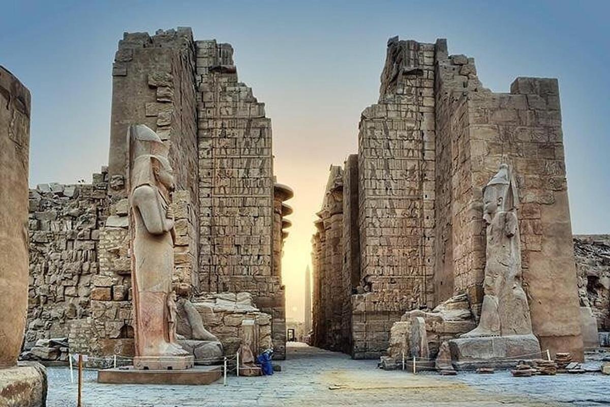 a temple with a statue in front of it