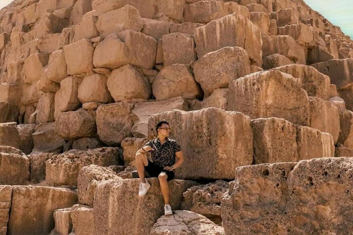 a man sitting on a pile of rocks