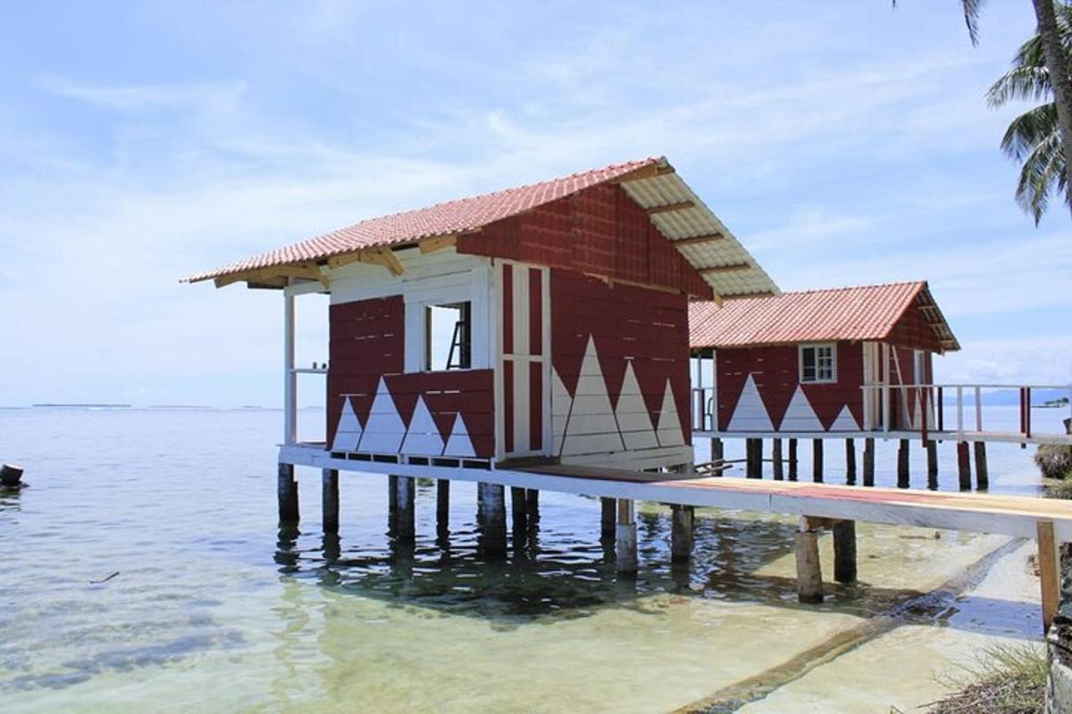 una piccola casa su un molo in acqua