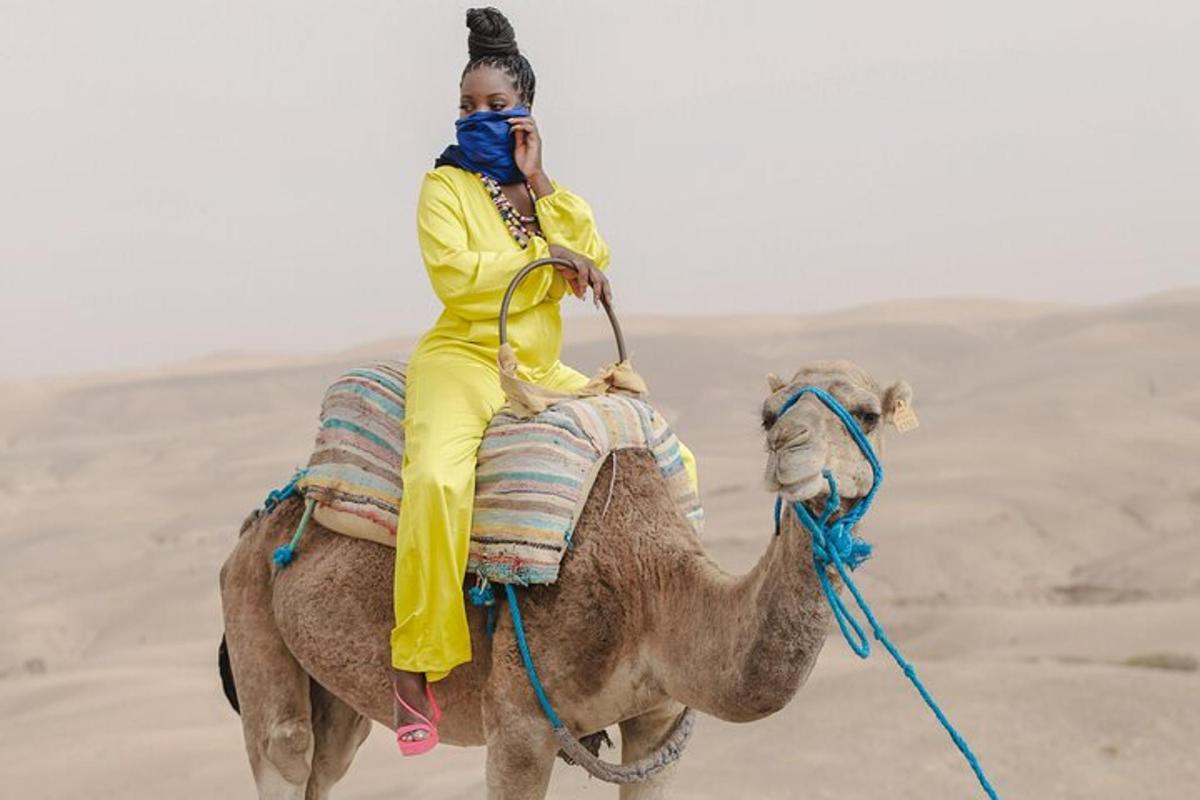 a woman riding on a camel in the desert