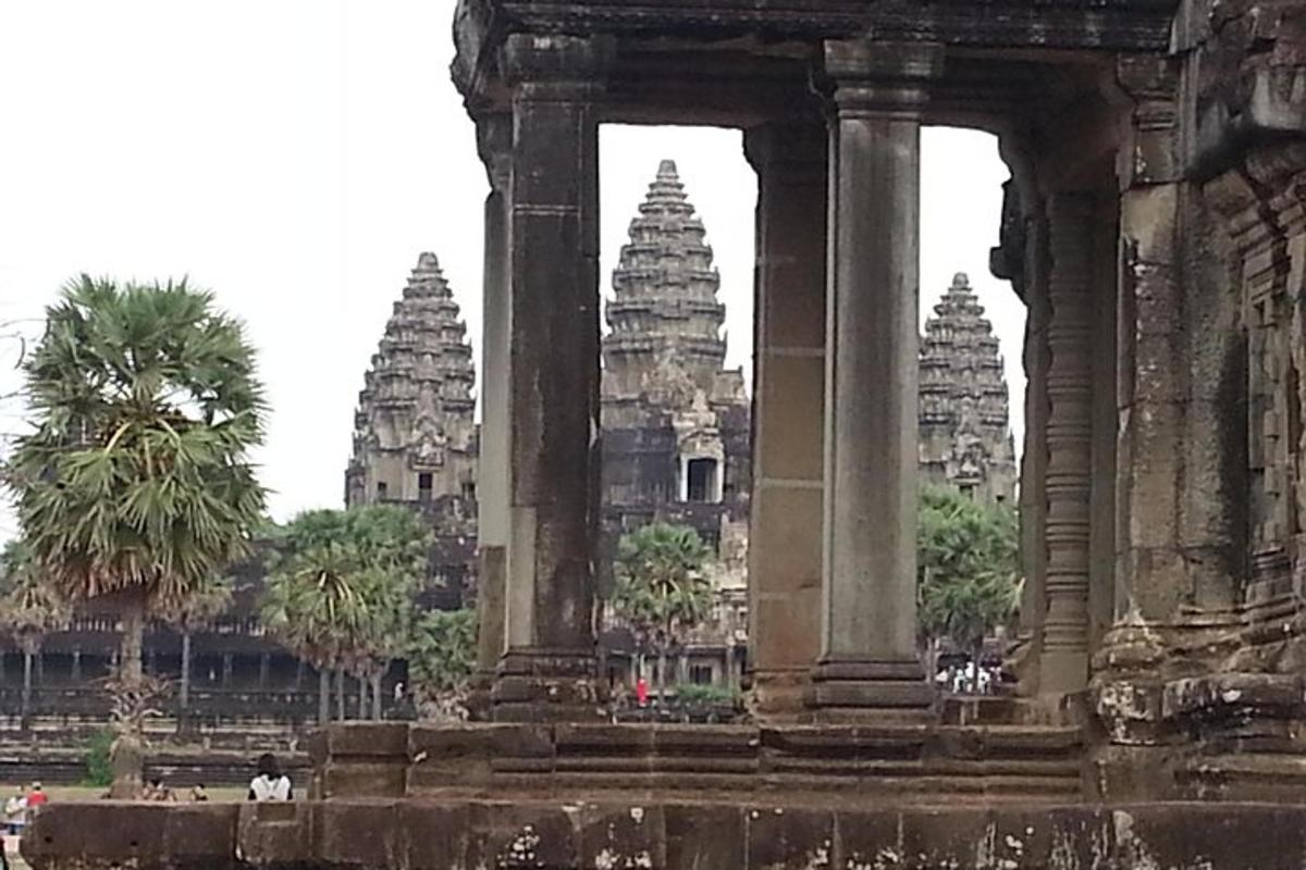 an ancient building with palm trees in the background