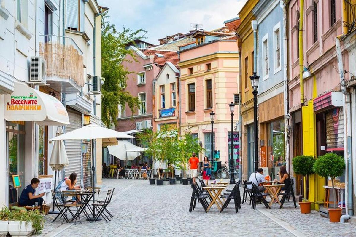 a street with tables and chairs and people sitting at tables