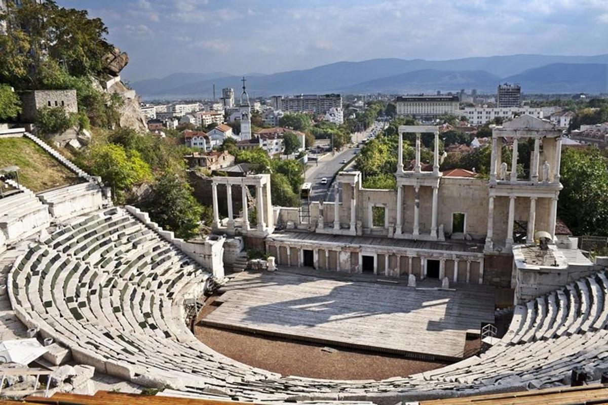 an empty amphitheater with a city in the background