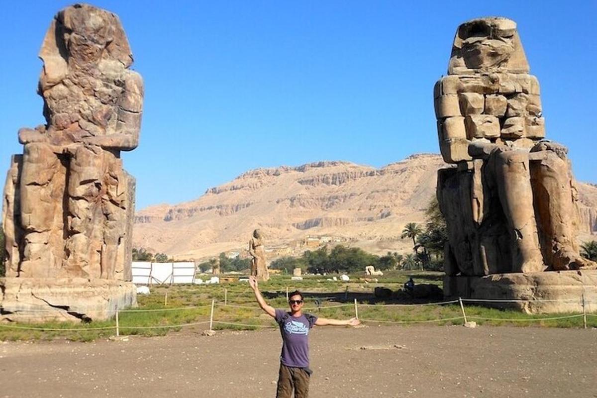 a man standing in front of a stone monument