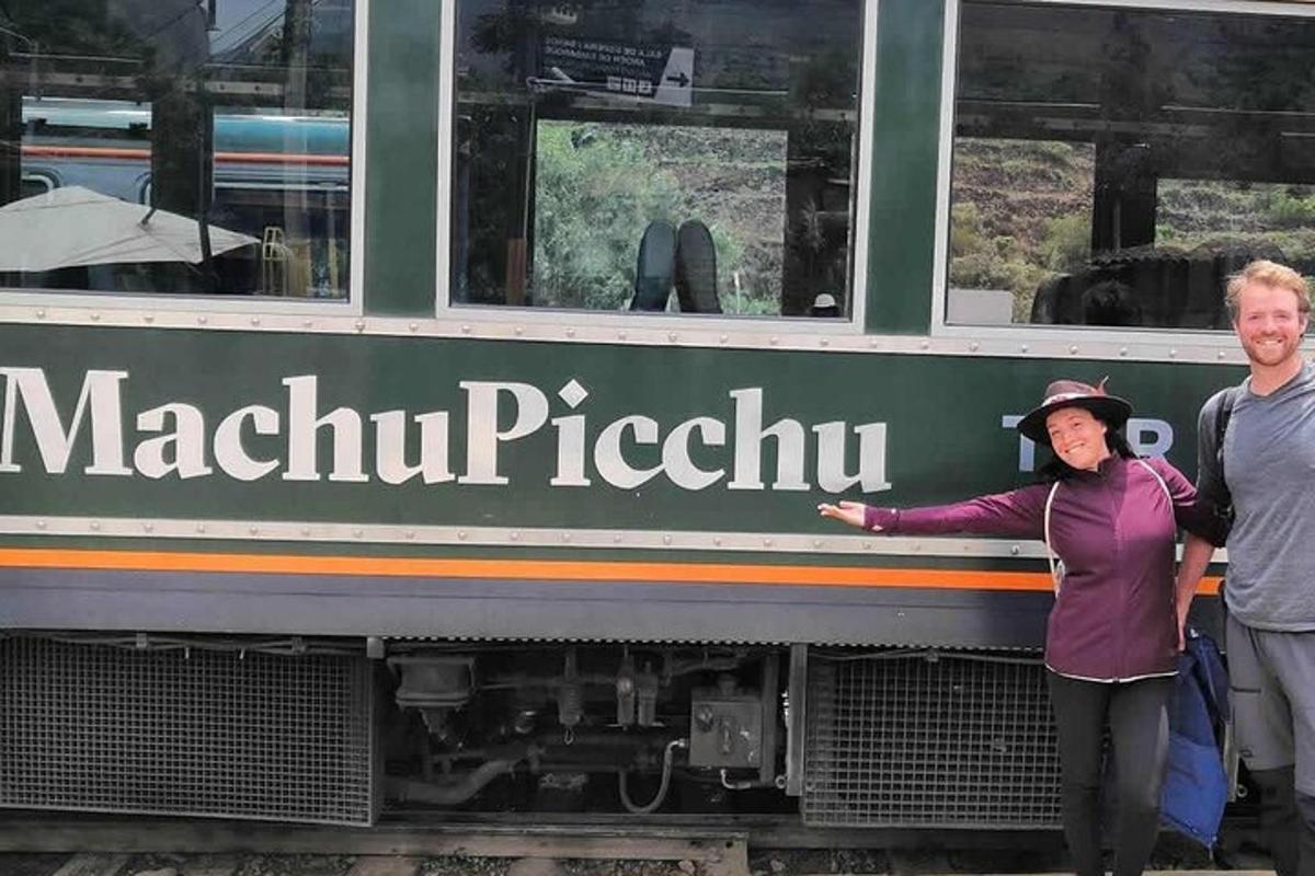 a man and a woman standing next to a train