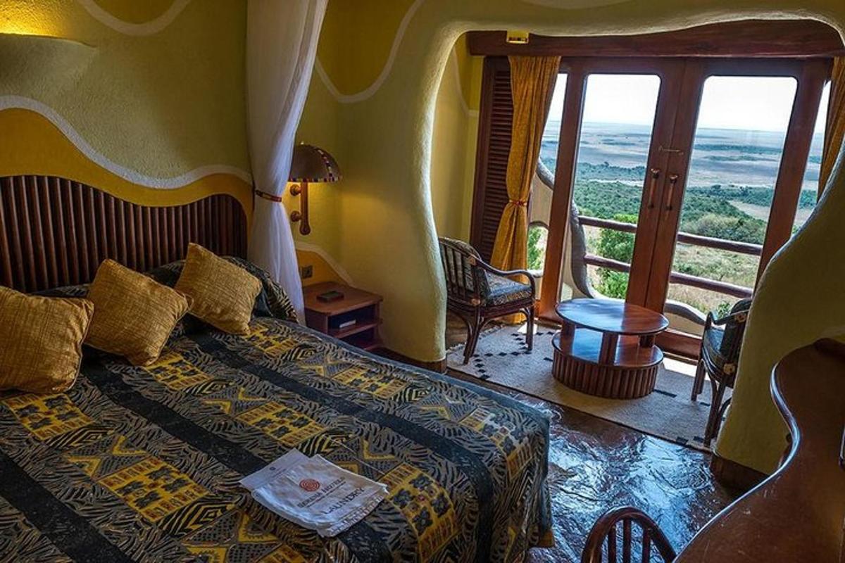 a bedroom with a bed with a view of the ocean