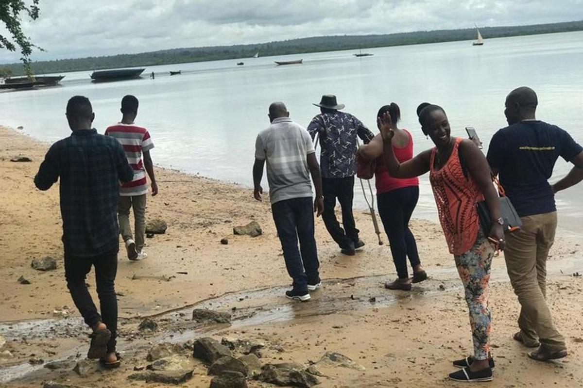 a group of people walking on the beach