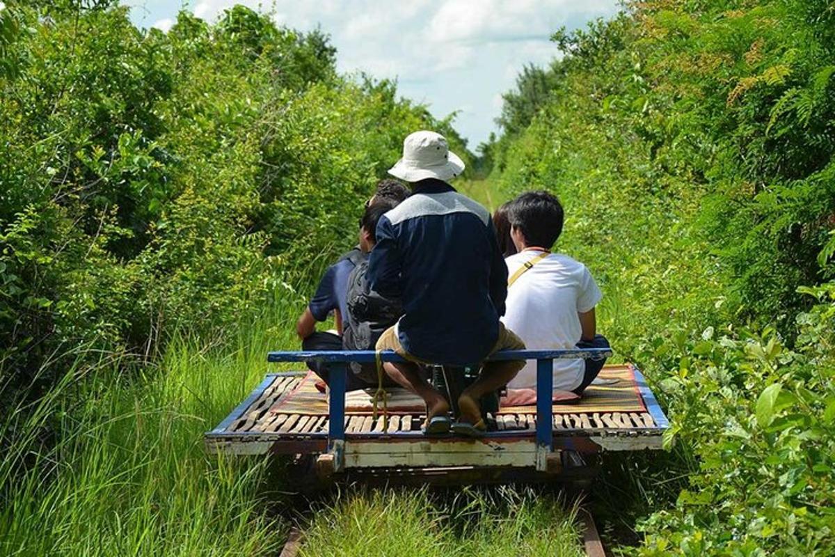 a group of people sitting on a bench on a trail