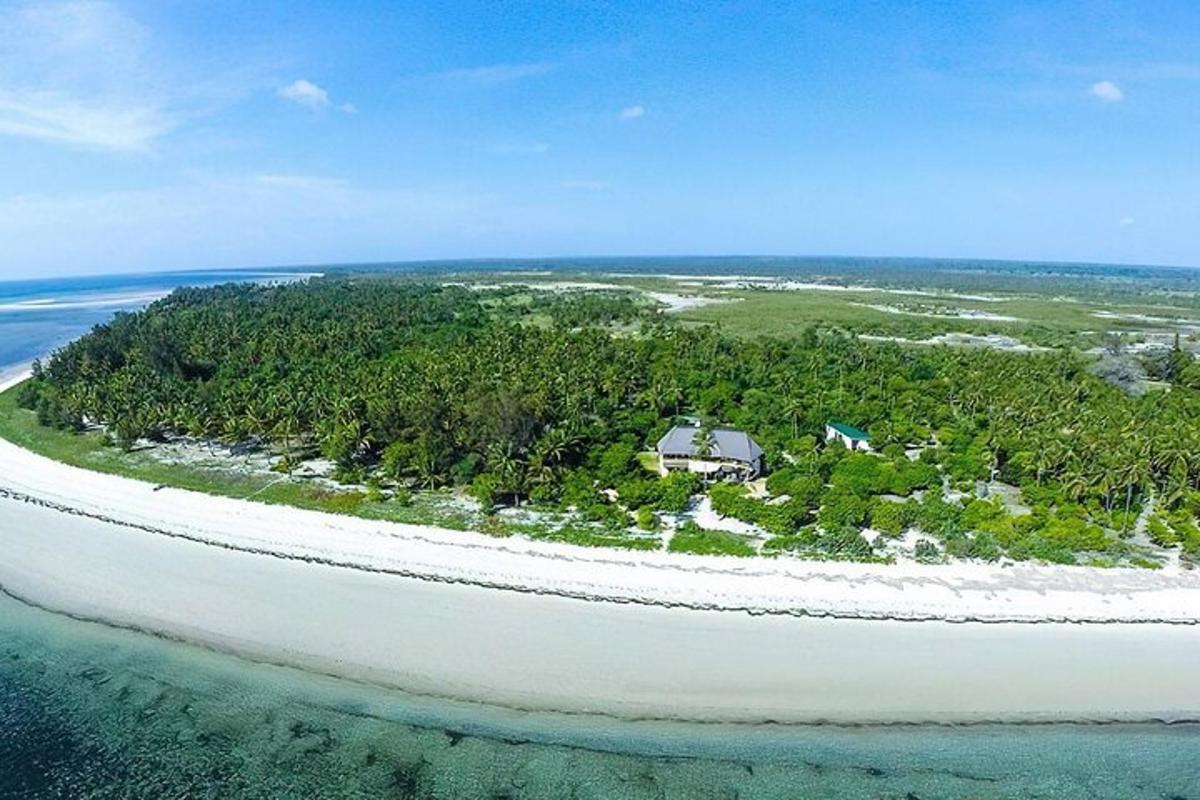 an island in the ocean with a house on it
