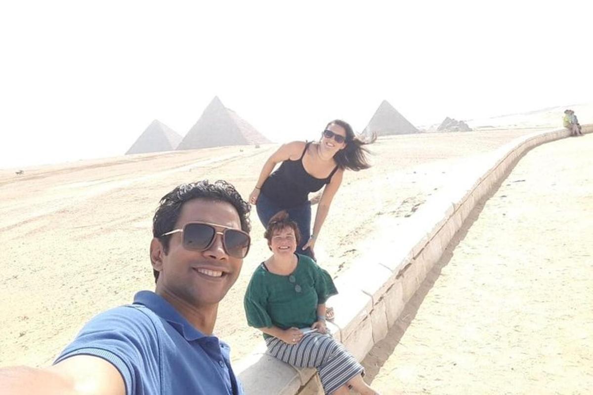 a man and a woman standing on a wall in the pyramids