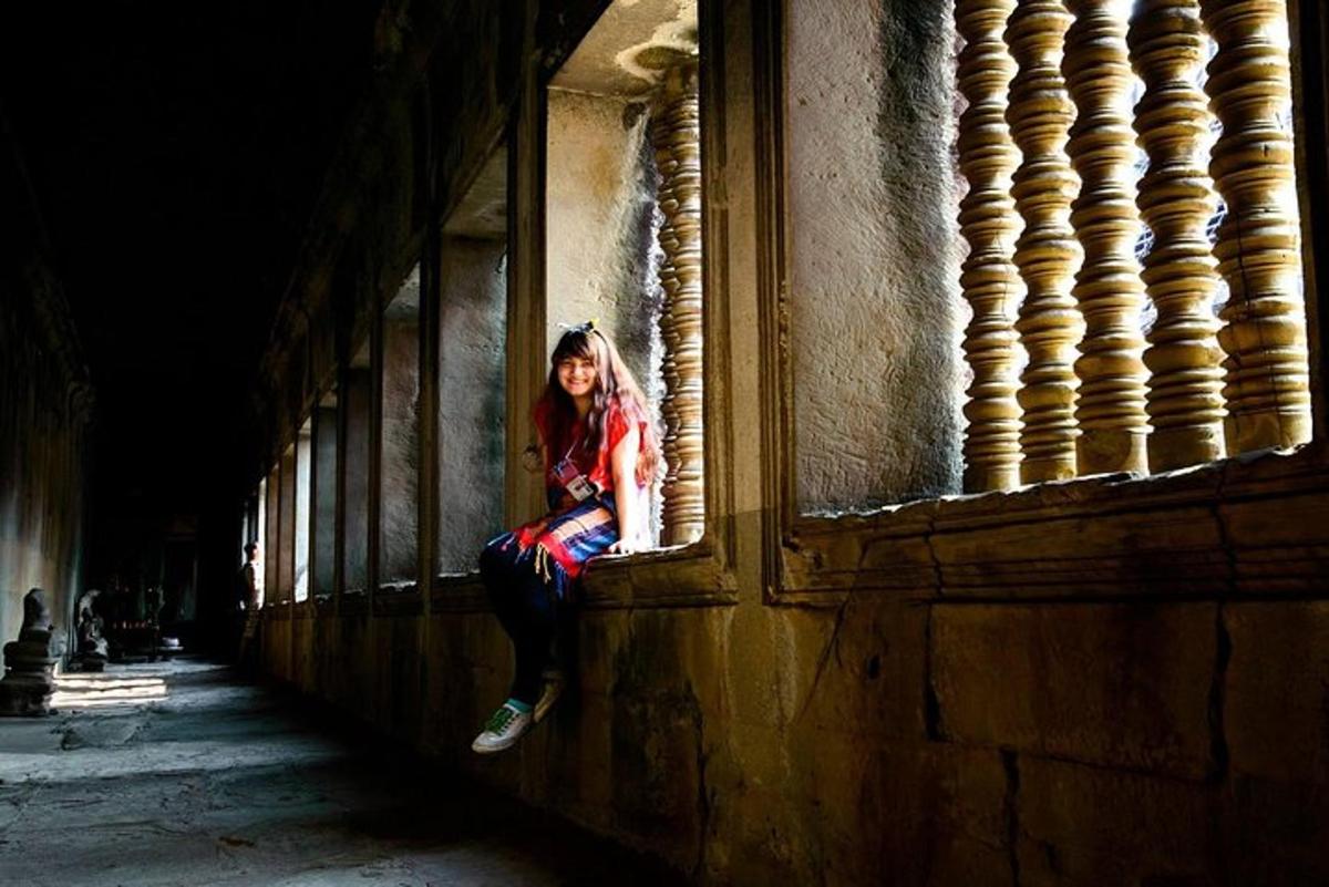 a woman sitting on a window sill in a building