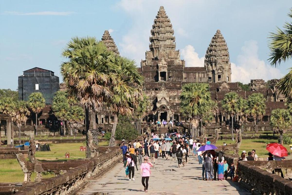 a group of people walking in front of a temple