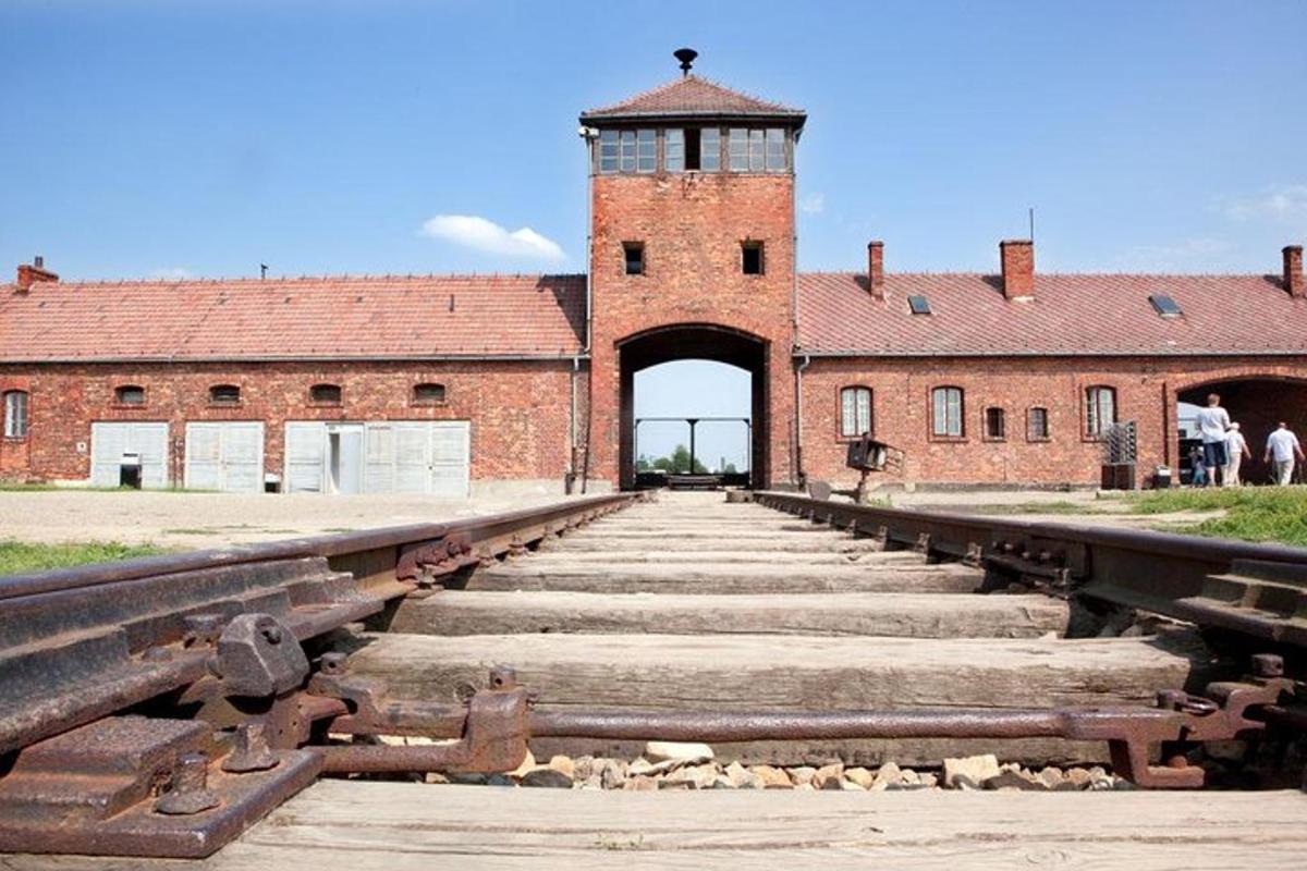 an old brick building with a gate and stairs