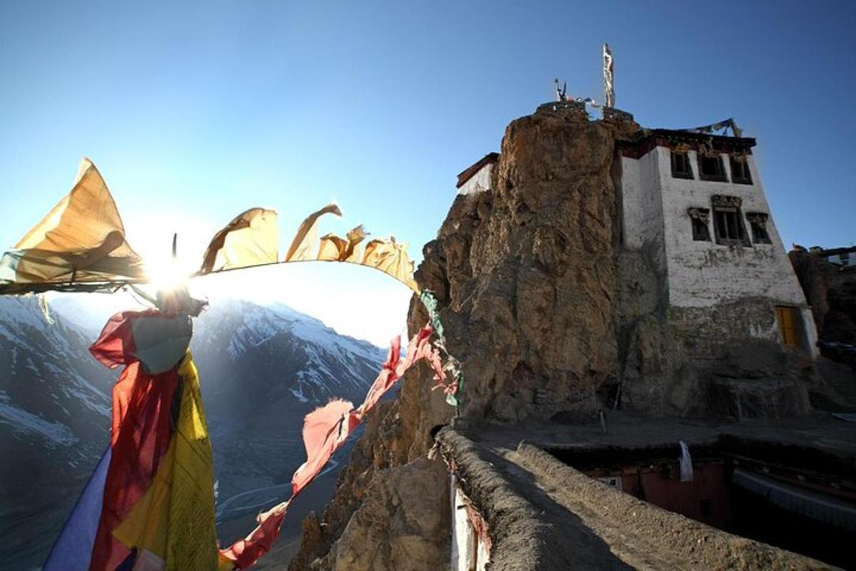 a person standing on top of a mountain with a flag