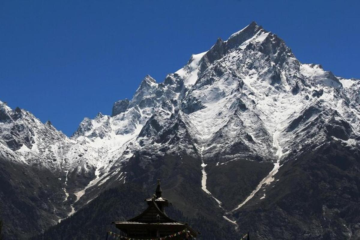 a snow covered mountain with a building in front of it
