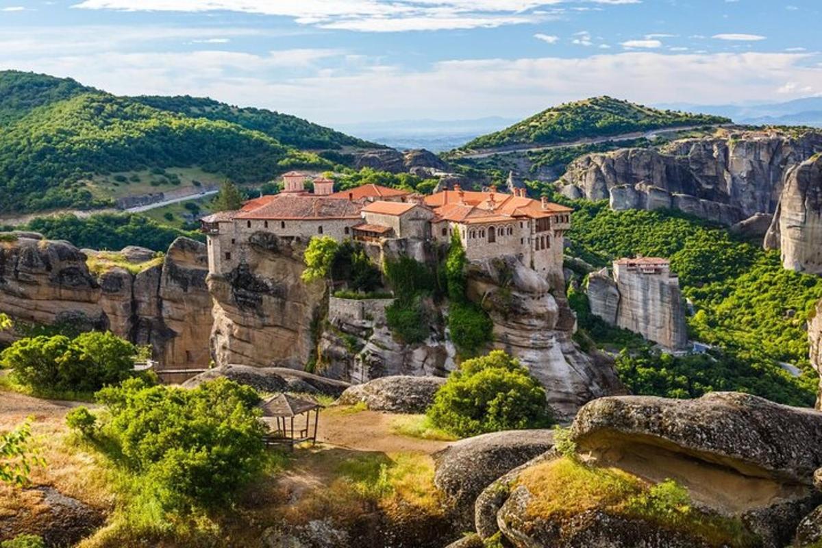 a castle on a cliff in the mountains