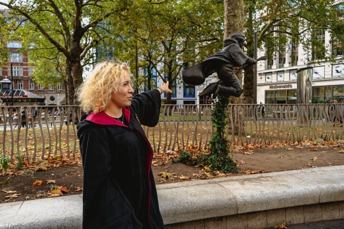 a woman standing in front of a statue of a boy