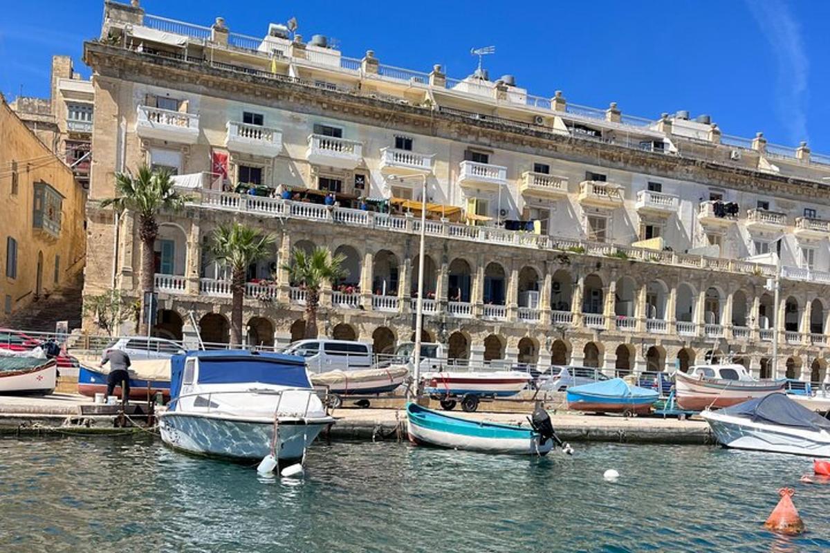 a large building with boats in the water in front