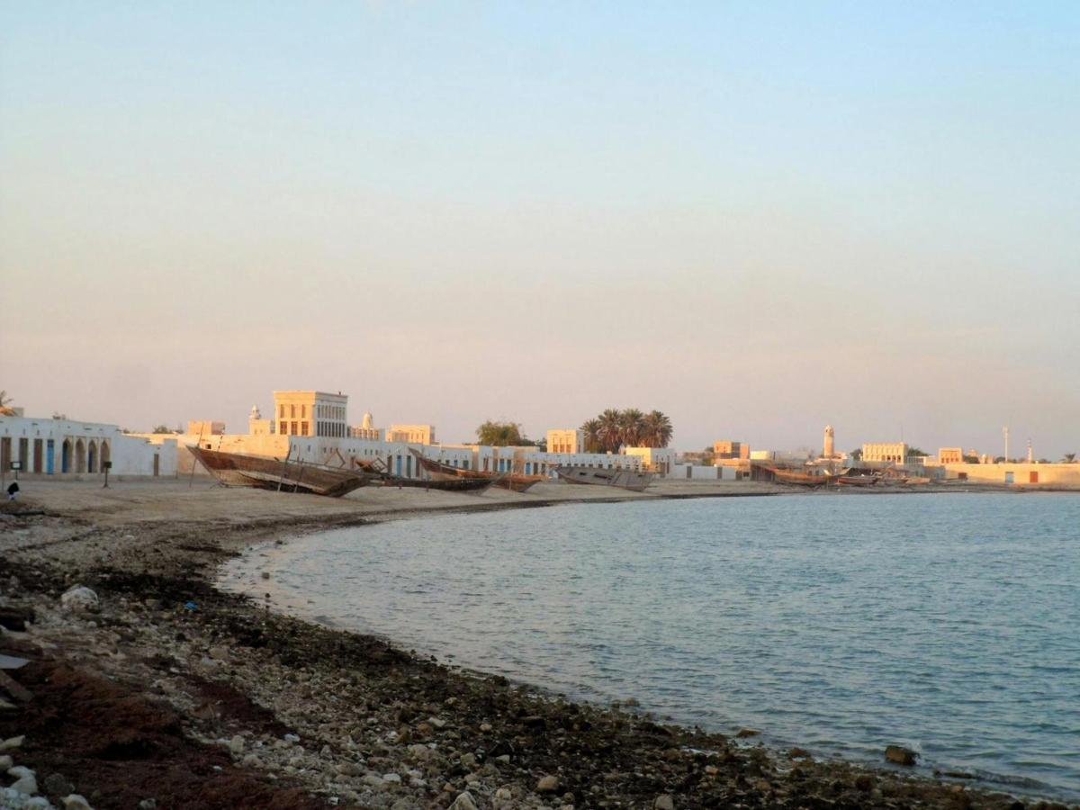 a view of a beach with buildings in the background