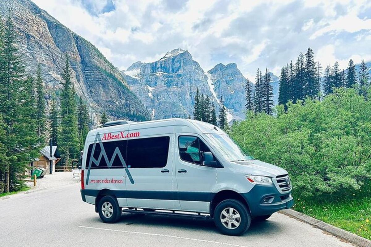 a white van parked on a road in front of mountains