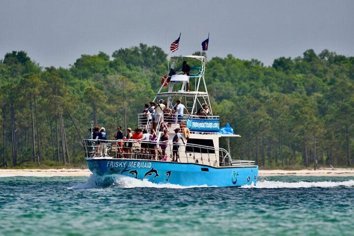 a group of people on a blue boat in the water