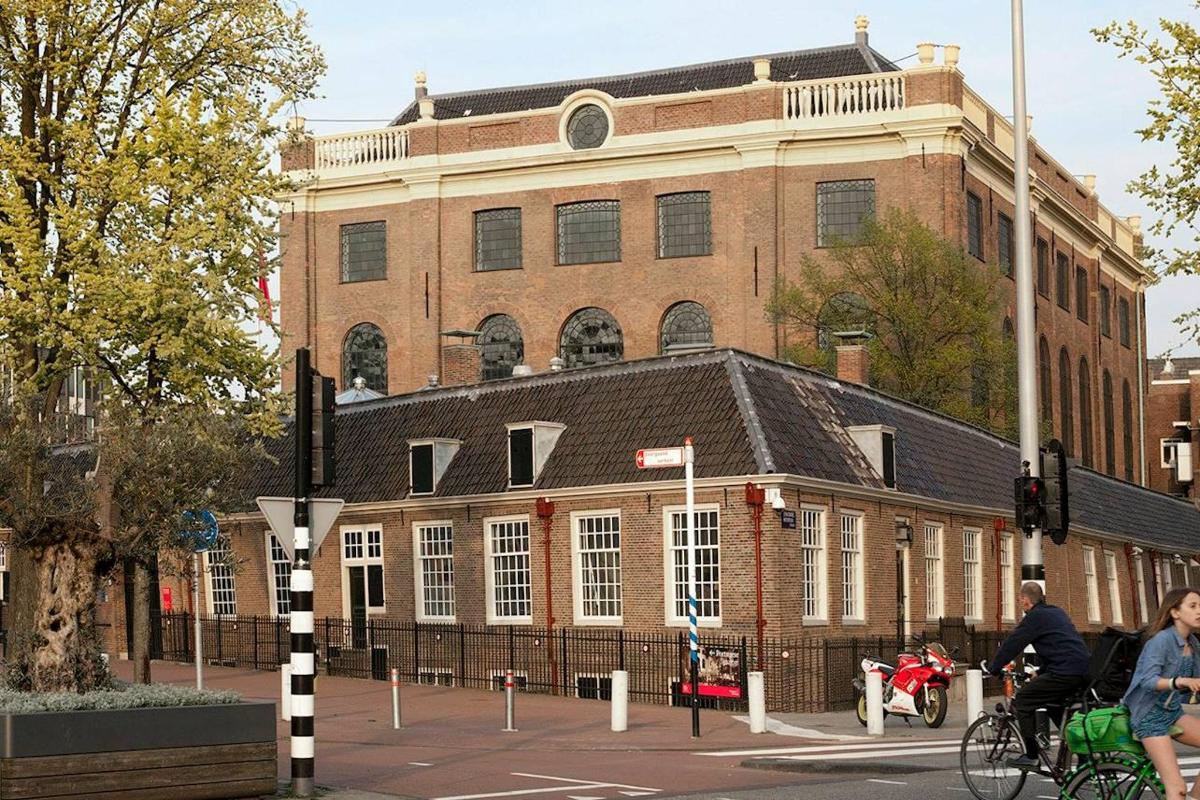 a large brick building in front of a street