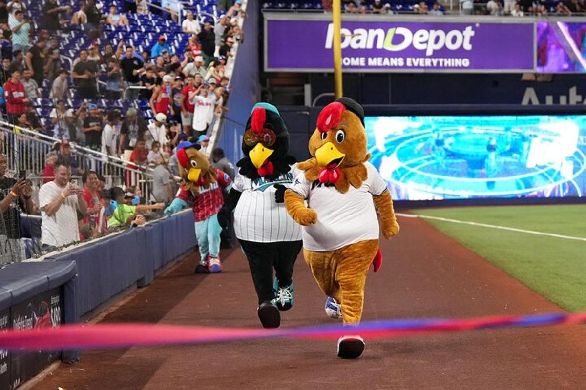 two mascots walking on the field at a baseball game