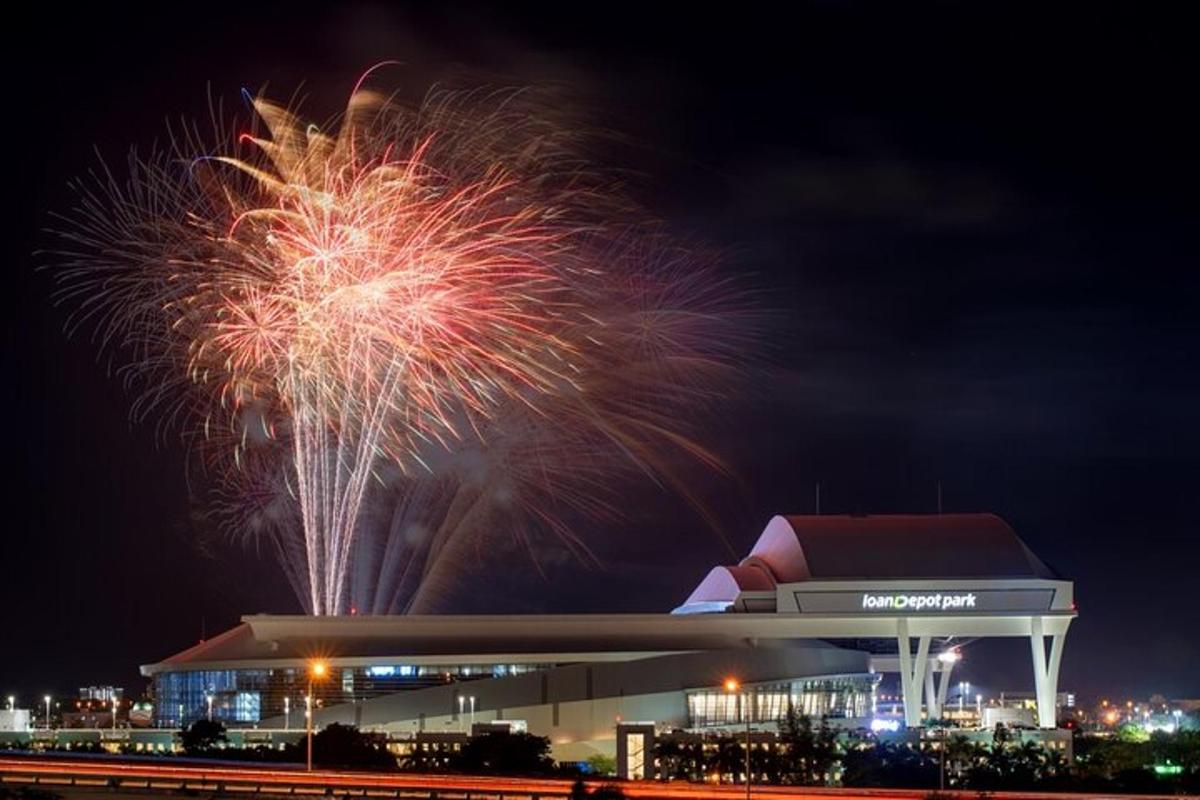 a fireworks display at a stadium with a building