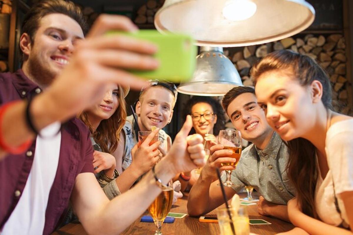 a group of people sitting at a table drinking wine