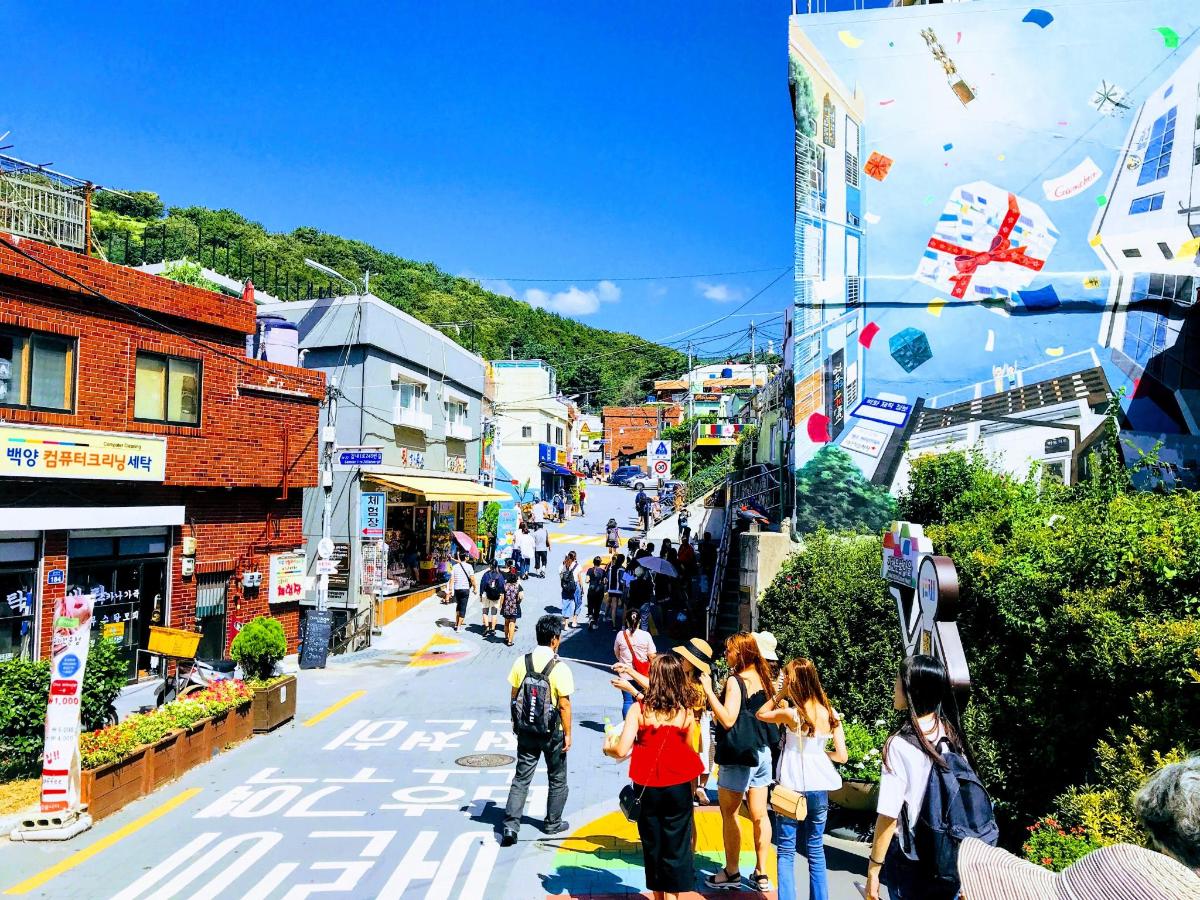 a group of people walking down a city street