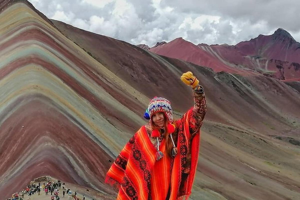 a woman standing in front of a painting of a mountain