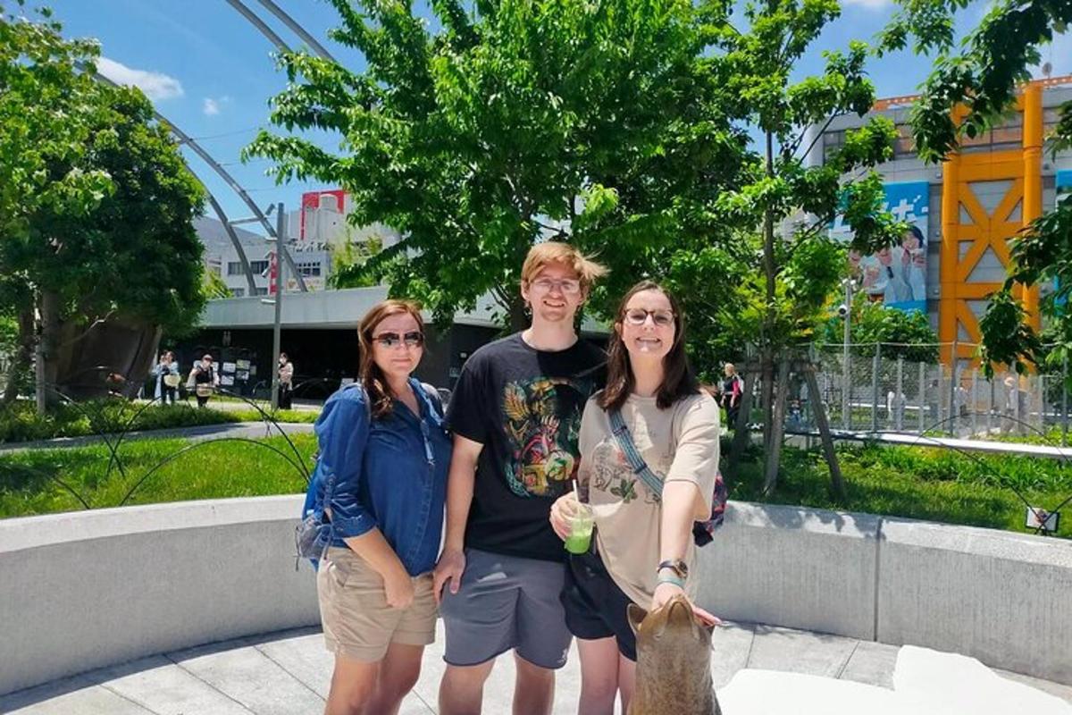 three people are posing for a picture in a park