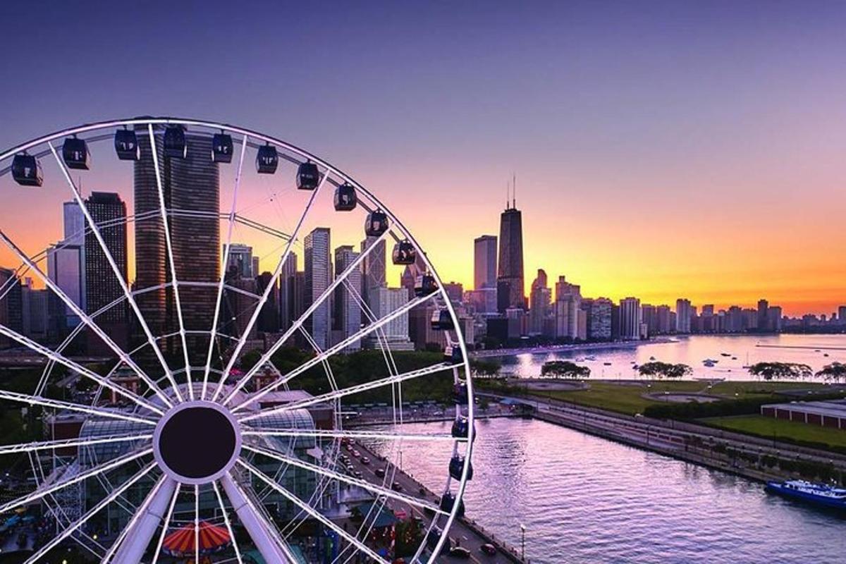 a ferris wheel in front of a city at sunset