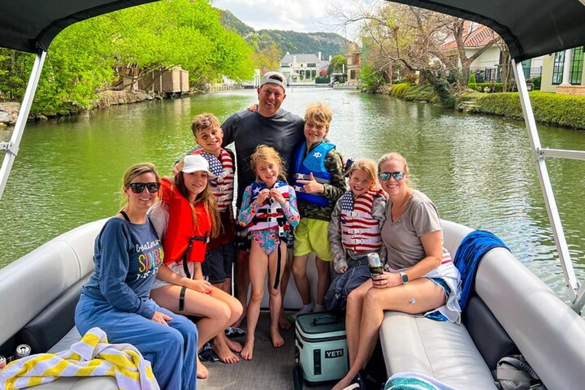 a group of people sitting on the back of a boat