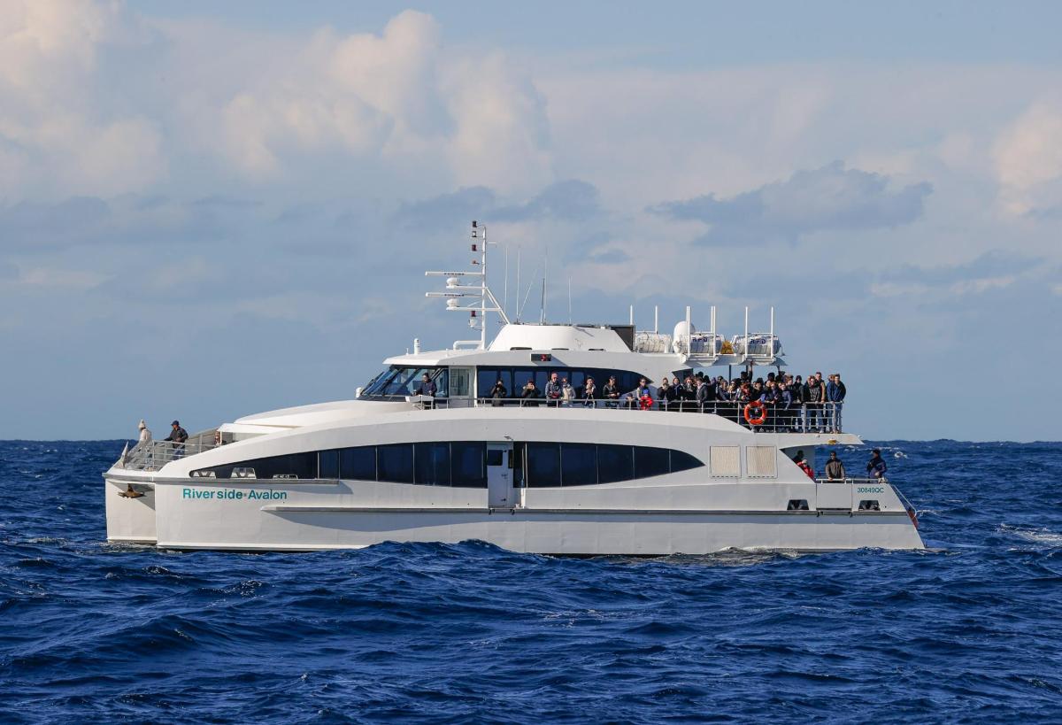 a group of people on a yacht in the ocean