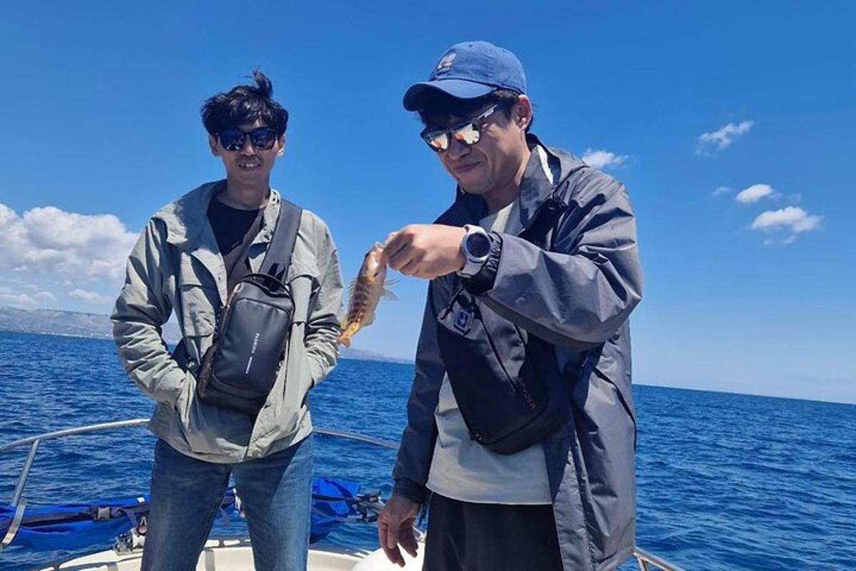 two men standing on a boat in the ocean