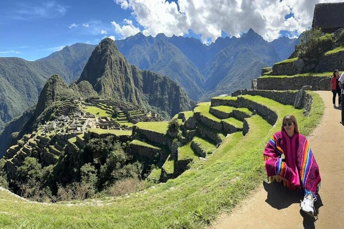 una donna seduta sul fianco di una collina con vista
