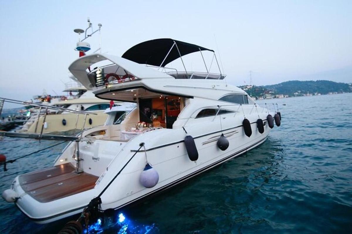 a white boat is docked in the water